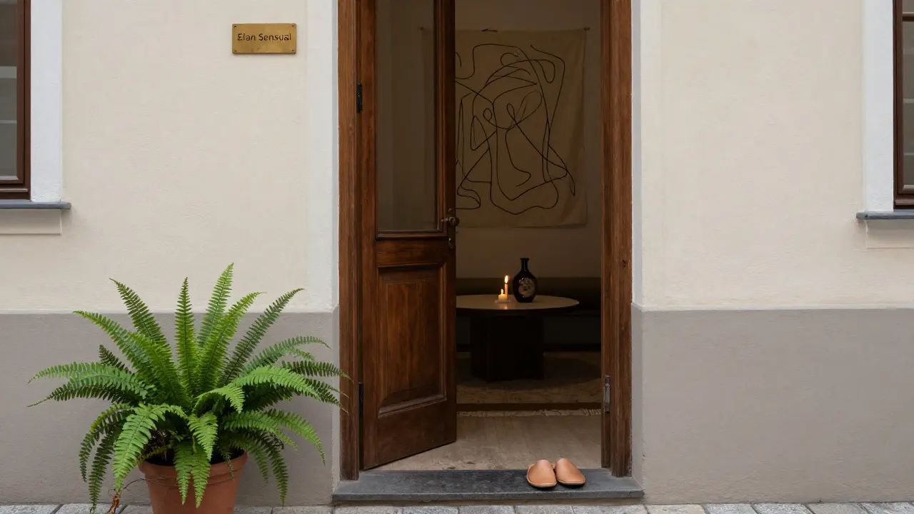 A quiet Prague massage studio entrance with a brass plaque and leather slippers by the door.