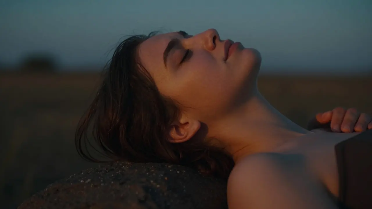 A person experiencing a peaceful emotional release and relaxation in a warm, cinematic setting.